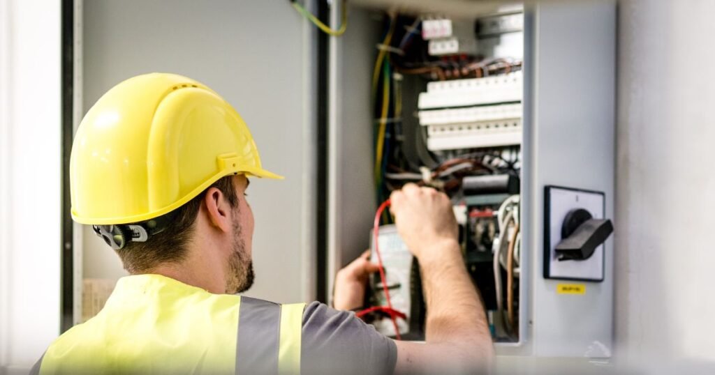 Male Electrician repairing electric panel